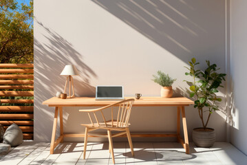 Obraz premium Modern workplace with a laptop on the terrace of the house