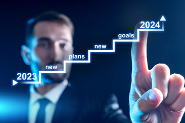 Businessman sets goals for 2024. Man draws graph on virtual screen. Staircase with strategy for...