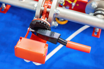 Industrial equipment closeup. Adjustment lever near metal pipe. Fragment of steel pipeline at...