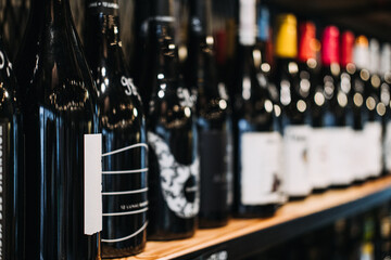 How choose wine. Assorted Wine Bottles on Display in a Store. A selective focus labels of a variety...