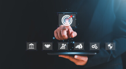 Businessman pointing hand at business target symbol icon with business strategy and action plan, targeting business concept, business development concept.