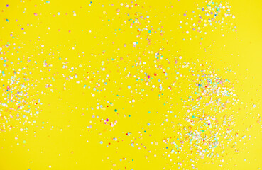 Colorful confetti on yellow table
