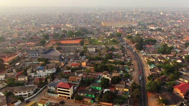 Aerial view of a crowded urban settlement in Accra, Ghana, showcasing dense housing, busy streets, and vibrant community life. Ideal for documentary, urban, and cultural projects.