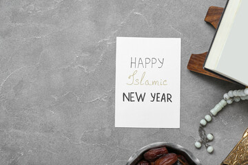 Card with text HAPPY ISLAMIC NEW YEAR, Koran and tasbih on grunge background
