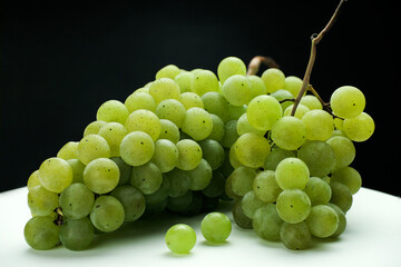 Green bunch of white grapes, Green bunch of grapes on a black background,