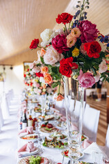 Wedding table with food and bouquet in a vase