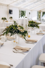 Decorated wedding tables with flowers and leaves