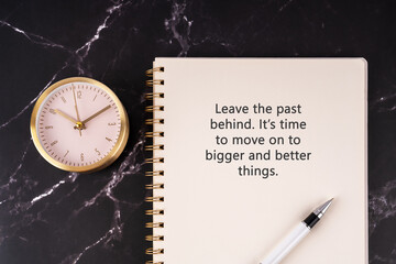 Inspirational quotes on notepad - Leave the past behind. It's time to move on to bigger and better...