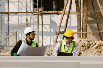 Engineers and Architect Caucasian looking at blueprint of building construction, planning the work in a professional. inspector is looking at steel structure and materials at construction site.