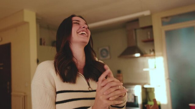 Smiling girl acting out word in the game of charades, gesturing and showing pantomime