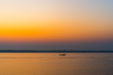 Fototapeta premium Beautiful Boat in river at dawn. Foggy landscape with boat during sunset on traditional boat in Sundarbans. 