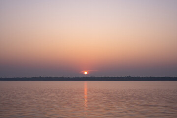 Naklejka premium Beautiful sunset sky with island. Sunset at the beach.