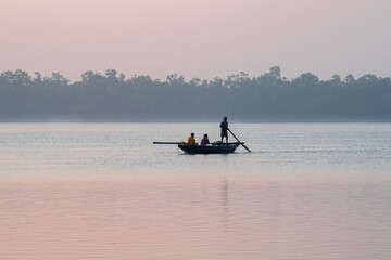 Beautiful Boat in river at dawn. Foggy landscape with boat during sunset on traditional boat in Sundarbans. 