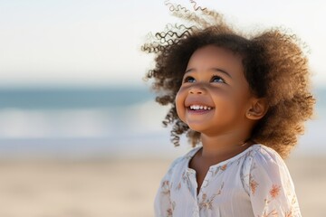 Portrait of happy little african girl on the beach - obrazy, fototapety, plakaty