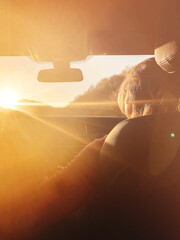 Woman in car during sunset