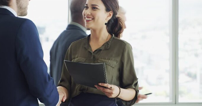 Business woman, handshake and job interview, Human Resources meeting or career introduction in lobby. Happy people or clients shaking hands with documents, resume and talking of recruitment or hiring