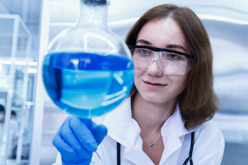 Young woman scientist conducting research investigations in a medical development laboratory....