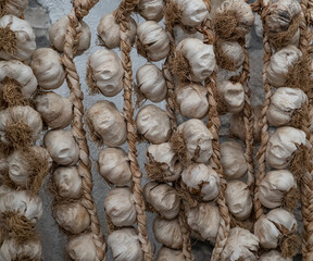 dried garlic on ropes against the wall.