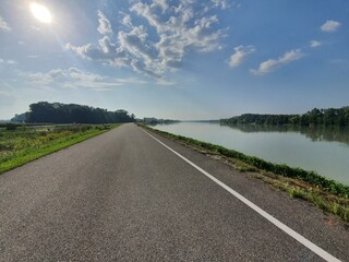 Amazing bike path near river on a sunny day in austria. Famous Donauradweg next to beautiful danube river in austria. Copy space for text. Travel and holidy concept