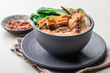 Crispy Pork Kare Kare (Peanut Sauce) with Vegetables and Shrimp Paste on the side 

