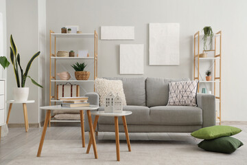 Grey sofa with cushions in interior of modern living room