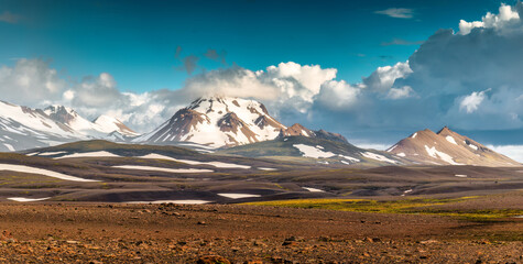 Volcanic mountain range with blue sky on wilderness among the Icelandic Highlands in summer