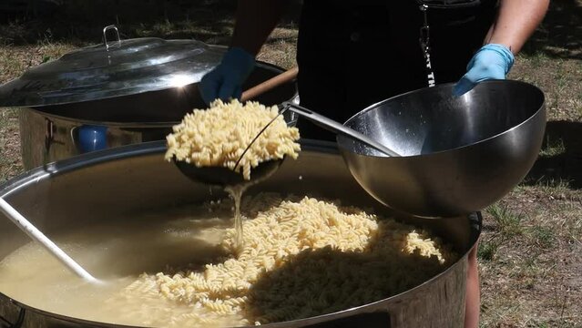 Tomato soup with pasta is a dish of Polish cuisine. Hot Zupa pomidorowa in a large cauldron at the field kitchen at a food fair. A popular soup made from grated tomatoes in their own juice.