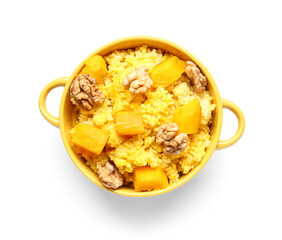 Pot of tasty millet porridge with pumpkin and nuts on white background