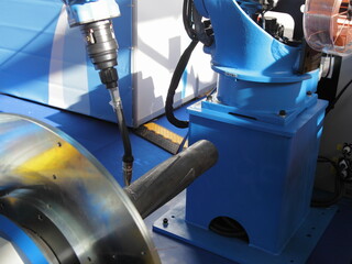 Automatic pipes welding MIG MAG in lathe process closeup - welding torch and welded detail