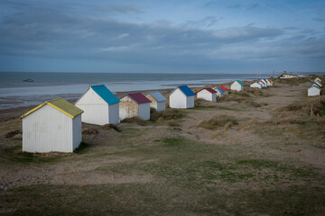 Gouville, France - 12 30 2023: View of colorful bathing wooden cabins of Gouville on the dunes.