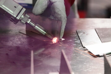 Laser beam welding of metal on welding table. LBW assembly details angle