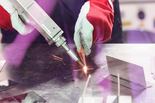 Laser beam welding of metal on welding table. LBW attention eyes
