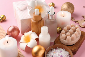 Composition with spa accessories, Christmas decorations and gift box on pink background