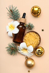 Composition with bottle of essential oil, sea salt and Christmas decor on color background