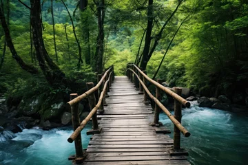 Fototapeten Rustic bamboo bridge crossing vibrant blue mountain river © Photocreo Bednarek