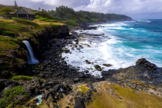 Aerial long exposure view of Senneville waterfall and the waves crashing on the south coast of Mauritius island