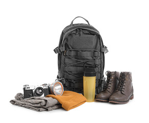 Set of camping equipment with backpack, photo camera and thermal bottle on white background