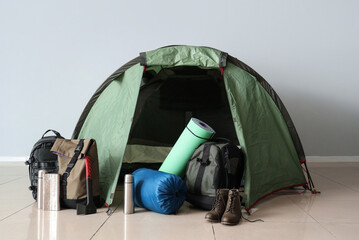 Camping tent with different hiking equipment indoors