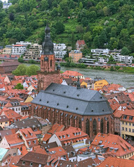 Church of the Holy Spirit in Heidelberg Old Town, Germany. View from the lower slope of Konigstuhl hill. The church was constructed between 1398 and 1515. - 701839080