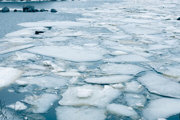 ice drift, ice floes float on the river in early spring, the river is opened from ice, snow melts