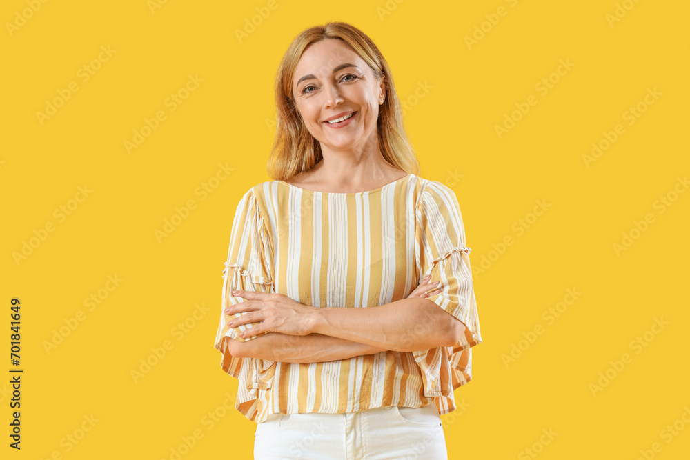 Canvas Prints Mature woman smiling on yellow background