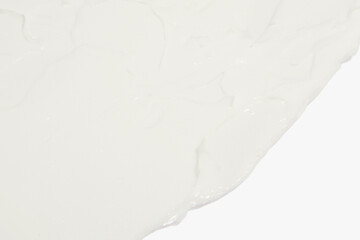 Obraz premium White cosmetic cream smeared on a white background.