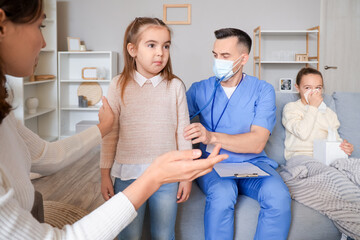 Obraz premium Doctor listening lungs of ill little girl with stethoscope at home