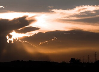 A Majestic Sunset Amidst Silhouetted Clouds