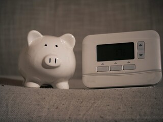 Piggy bank savings and central heating thermostat controls