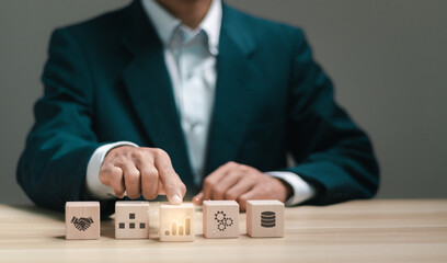 Businessman stacking wooden blocks with business analysis icon for market research concept....