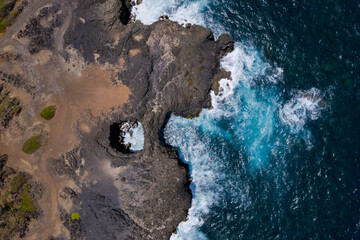 Aerial top view of 'Pont Naturel' which is a natural bridge formed by lava many years ago on the south coast of Mauritius island.