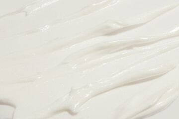 Thick white cosmetic cream applied to the surface. texture of the cream close-up.