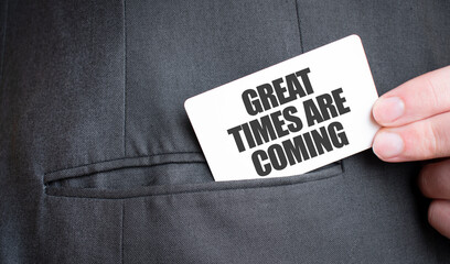 Card with GREAT TIMES ARE COMING text in pocket of businessman suit. Investment and decisions...