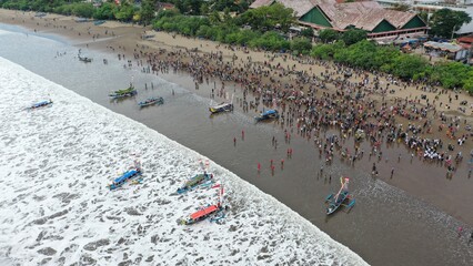 Pangandaran Beach, West Java, Indonesia. A stunning scene where a group of tourists celebrate the...